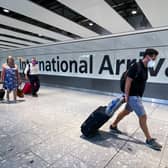 Library image of passengers in the arrivals hall at Heathrow Airport,