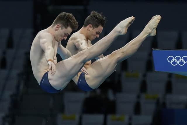 BIG DIVE: Tom Daley and Matty Lee, right, compete during the men's synchronized 10m platform diving final at the Tokyo Aquatics Centre. Picture: AP/Dmitri Lovetsky