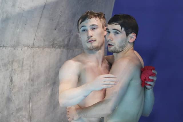 BAD DAY AT THE OFFICE: Daniel Goodfellow and Jack Laugher, right, embrace after their final dive during the Men's Synchronised 3m Springboard final at Tokyo Aquatics Centre. Picture: Maddie Meyer/Getty Images