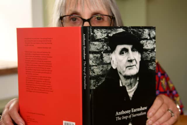 Gail Earnshaw from Chapel Allerton in Leeds with a  book about her late husband Anthony Earnshaw 'The Imp of Surrealism' in the flat he did some of his paintings Writer: Byline: Gary Longbottom