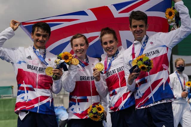 The team from Britain celebrates after winning the gold medal in the mixed relay triathlon at the 2020 Summer Olympics. Picture: AP Photo/Francisco Seco.