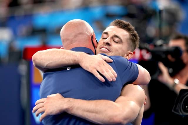 Great Britain's Max Whitlock hugs his coach Scott Hann after winning the Men's Pommel Horse Final at the Ariake Gymnastics Centre. Picture: Mike Egerton/PA