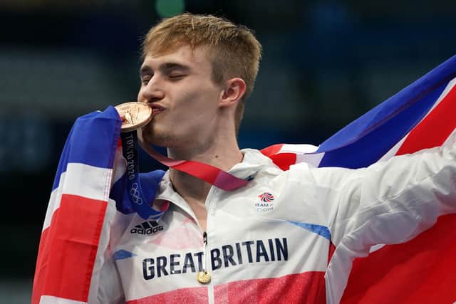 PODIUM KING: Jack Laugher celebrates on the podium with the bronze medal for the Men's 3m Springboard at Tokyo Aquatics Centre.. Picture: Martin Rickett/PA