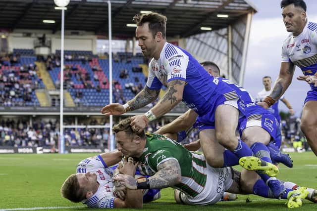 Hard to take: Leeds's Brad Dwyer and Richie Myler thought they had prevented Warrington's Josh Charnley from scoring a try, but the referee and video ref thought otherwise. Picture by Allan McKenzie/SWpix.com