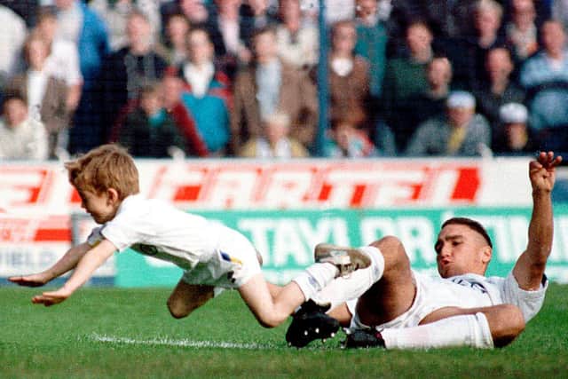 Vinnie Jones pictured tackling a Leeds United mascot at Elland Road. Pic: Varley Picture Agency