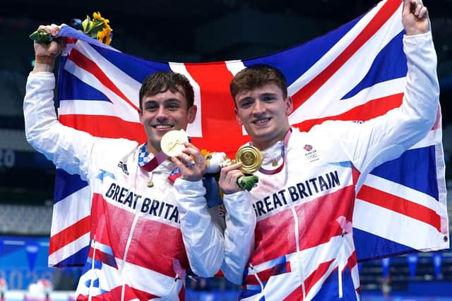 TOP OF THE WORLD: Tom Daley (left) and Matty Lee celebrate winning gold in the Men's Synchronised 10m Platform Final at the Tokyo Aquatics Centre. Picture: Adam Davy/PA