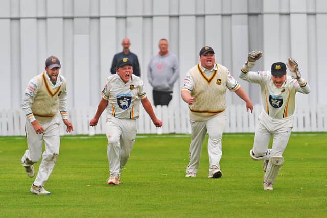 Pudsey St Lawrence players, Barrie Frankland, Charlie Parker, Chris Marsden and Charlie Best celebrate after Best had caught out New Farnley opener Lee Goddard for 15 off the bowling of Josh Priestley. Picture: Steve Riding.