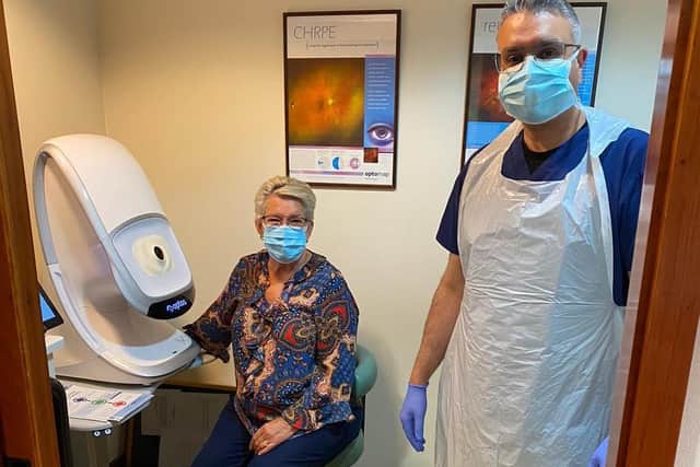 Lyn Inman and optometrist Pritpal Summan with the practice’s Optomap machine at Brosgill Opticians in Roundhay.