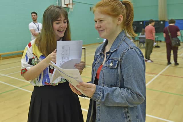 Farnley Academy students, Louise Cooper who achieved 9 nines with Lucy Crabbe who achieved 8 nines and 1 eight.