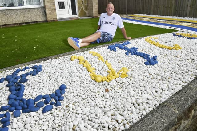 Leeds United fan Andy Lubgan in his garden. Photo: Steve Riding.