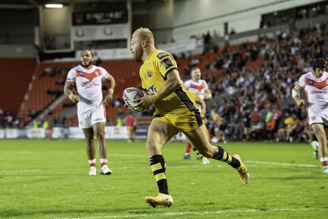 Over he goes: Tigers forward Oliver Holmes scores their opening try. Picture by Allan McKenzie/SWpix.com