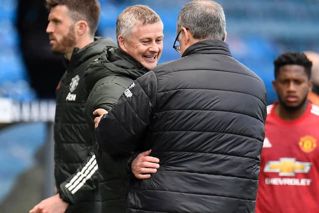 THIRD MEETING: Between Manchester United boss Ole Gunnar Solskjaer, left, and Leeds United head coach Marcelo Bielsa, right, after their two encounters last season. Photo by PETER POWELL/POOL/AFP via Getty Images.