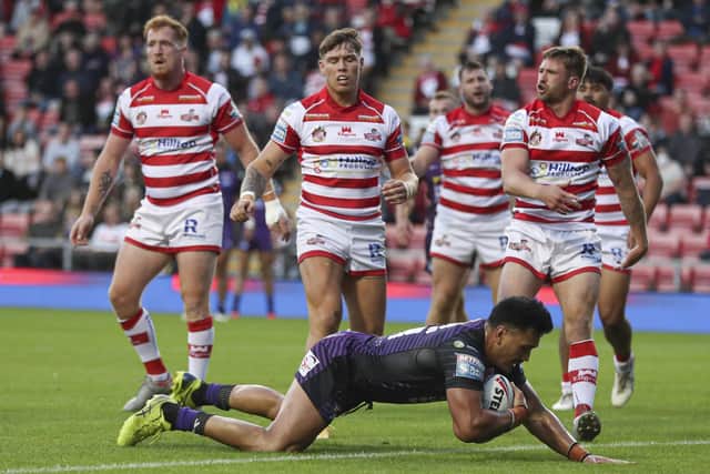Watching on: Leeds forward Zane Tetevano goes through a static Leigh defence to score the first try. Picture by Paul Currie/SWpix.com