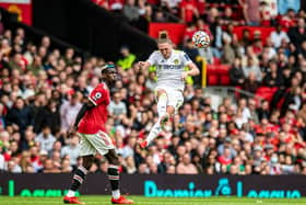 STRIKE IN VAIN: Luke Ayling, right, scored a stunning first goal for Leeds United but the Whites were blitzed 5-1 by a Manchester United side featuring Paul Pogba, left, at Old Trafford. Picture by Tony Johnson.