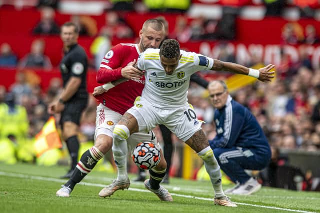 Raphinha holds off Manchester United's Luke Shaw. Picture: Tony Johnson.