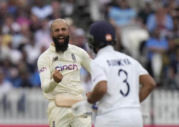Off you go: England's Moeen Ali, left celebrates after taking the wicket of India's Ajinkya Rahane caught behind. (AP Photo/Alastair Grant)