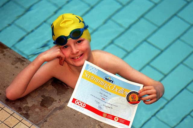 Jason Archer, nine, with his Kia-Ora/ASA Swimming challenge award gold medal at Bramley Baths in December 1996. Picture: Dan Oxtoby