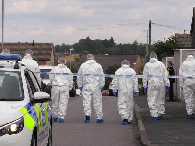 Forensic officers comb the scene at Whinmoor, Leeds, after a murder investigation is launched into the death of Eileen Barrott