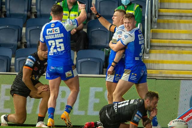 Ash Handley, centre, celebrates a try against Castleford. Picture by Bruce Rollinson.