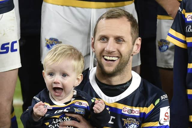 Rob Burrow with son Jackson at a fundraising match at Headingley in January last year. Picture by Steve Riding.
