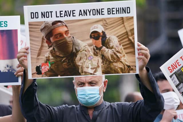 Former Afghan interpreters and veterans hold a demonstration in Parliament Square, London, calling for support and protection for Afghan interpreters and their families. Picture date: Wednesday August 18, 2021.