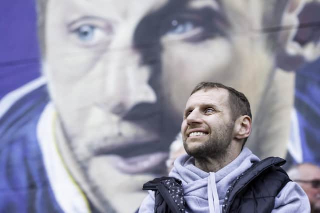 Rob Burrow at a mural of himself painted on the side of the Leeds University student building.