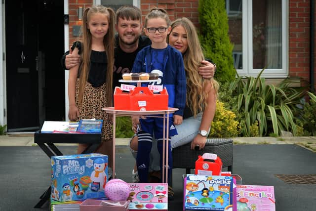 Seven-year-old Scott Summers has set up a charity stall outside his house in Cross Gates to raise money for Cancer charities, after suffering from the disease himself....Pictured with his parents Scott and Sam and sister Eight-year-old Alara