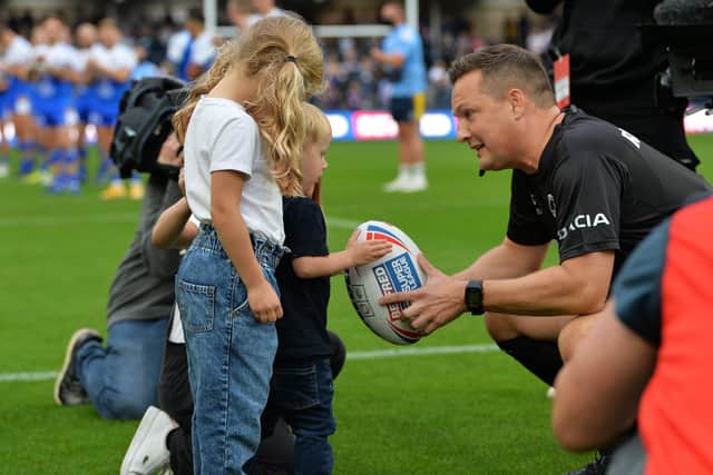 Touching moment: 
Leeds Rhinos legend Rob Burrow's children, Macy, Maya and Jackson, bring out the match ball to referee Ben Thaler.

Picture: Jonathan Gawthorpe