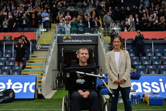 Welcome back: Rhinos legend Rob Burrow and his wife Lindsey on the pitch before the win over Huddersfield. Picture: Jonathan Gawthorpe