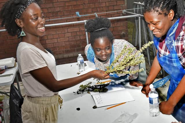 Matilya Njau, left with children at the gardening session which was one of the East Street Arts summer school events.