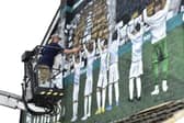 Artist Adam Duffield completing the new Leeds United mural near Elland Road. Pic: Steve Riding