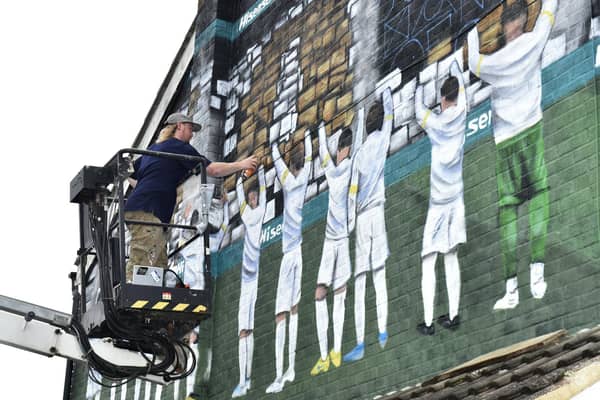 Artist Adam Duffield completing the new Leeds United mural near Elland Road. Pic: Steve Riding