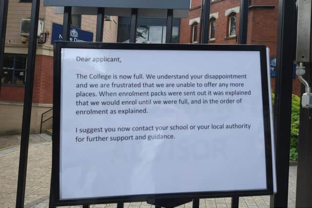 A sign posted outside the college, where upset students and their parents gathered on Thursday
