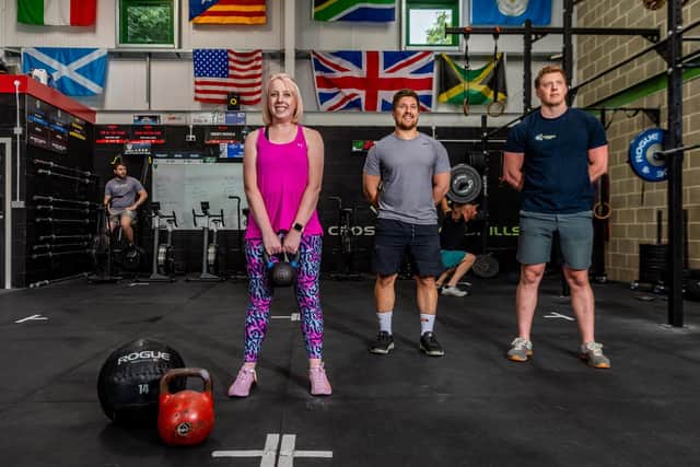 Laura Collins, YEP Editor, pictured with Dan Jeffrey, owner at Crossfit CrossHills, and coach Chris Hull. Pic: James Hardisty