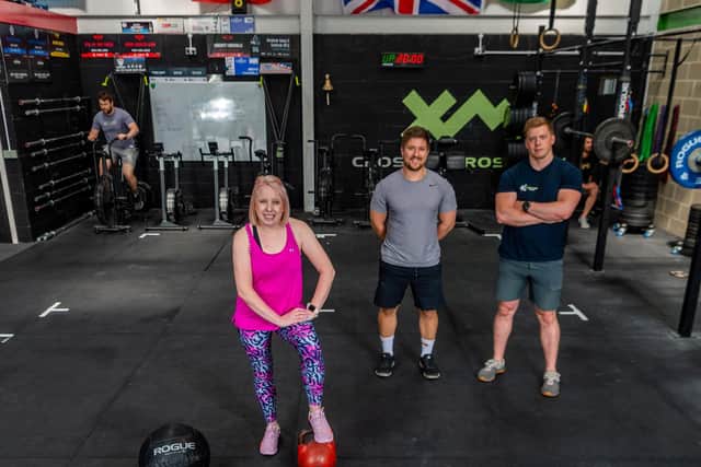 Laura Collins, YEP Editor, with CrossFit CrossHills owner Dan Jeffrey and coach Chris Hull. Pic: James Hardisty