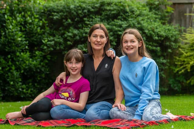 Tina Pinder - pictured with her daughters Lola, eight, and Gracie, 12 - will take on two marathons for Prostate Cancer UK