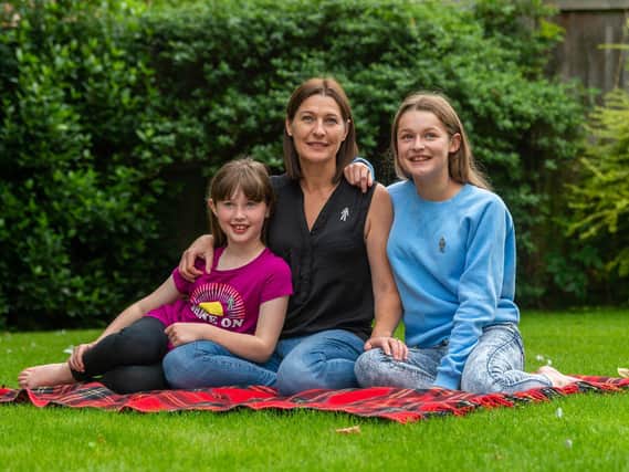 Tina Pinder - pictured with her daughters Lola, eight, and Gracie, 12 - will take on two marathons for Prostate Cancer UK