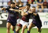 Wigan's Oliver Gildart is tackled by Leeds Rhinos' Harry Newman and Rhyse Martin. Picture: Paul Currie/SWpix.com.