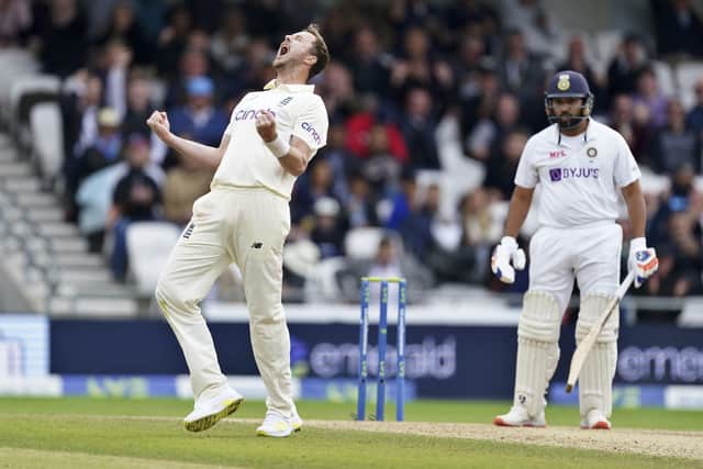 England's Ollie Robinson, left, celebrates the dismissal of India's Rohit Sharma, right. (AP Photo/Jon Super)