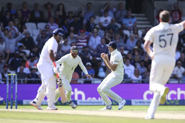 England's Craig Overton celebrates with England's Jonny Bairstow after taking the wicket of India's Rishabh Pant on day four at the Emerald Headingley. Picture: Nigel French/PA