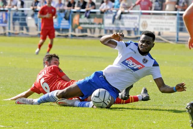 Guiseley's Lebrun Mbeka is fouled by Fabien Robert of Gloucester City. Picture: Steve Riding.