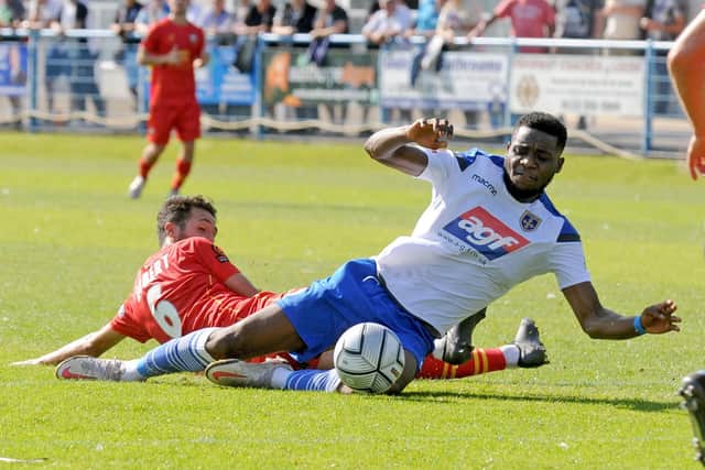 Guiseley's 
Lebrun Mbeka is fouled by Fabien Robert of Gloucester City. Picture: Steve Riding.