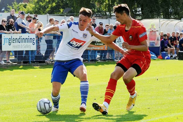 Guiseley's Jacob Gratton on Gloucester City's Ryan Galvin during the Lions' 2-1 victory yesterday. Picture: Steve Riding.