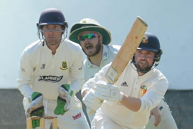 All eyes on the boundry as Townville's Jonny Booth strikes the ball on the way to 53 and a Bradford Premier League win over New Farnley. Picture: Steve Riding.