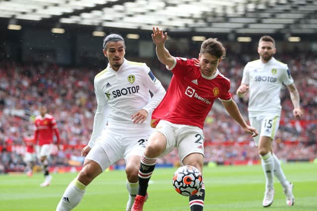 JOINING YOU? Manchester United's Dan James, front, looks to hold off Leeds United's Pascal Struijk in the recent 5-1 defeat at Old Trafford as Stuart Dallas looks on. The trio could soon by Whites team mates. Photo by Alex Morton/Getty Images.