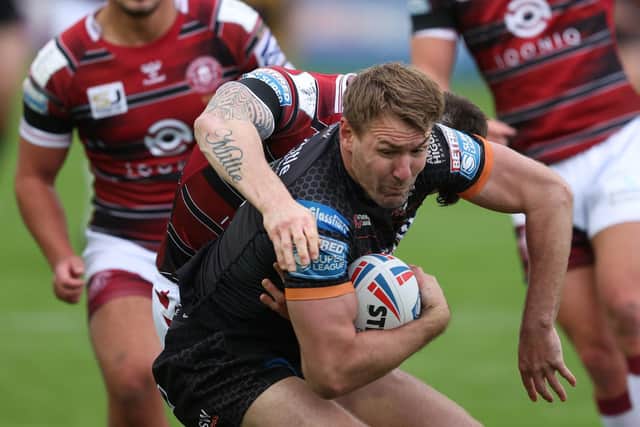 Castleford Tigers captain Michael Shenton, on his return from a fractured cheekbone, is met by the Wigan Warriors defence. (John Clifton/SWpix.com)