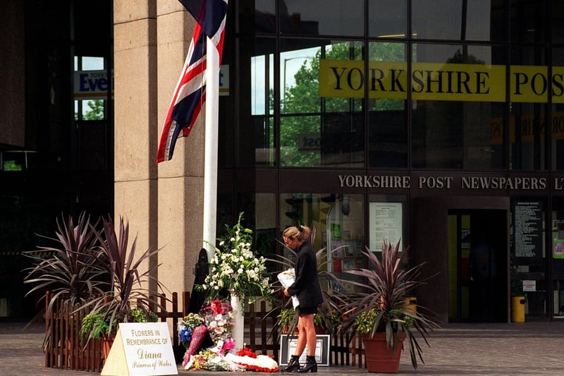 A member of the public lays some flowers outside the Yorkshire Evening Post in memory of Diana, Princess of Wales.