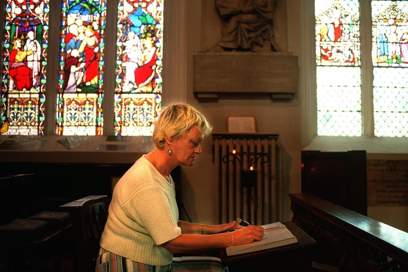 Sandra Halford signs the book of condolence at Leeds Parish Church.