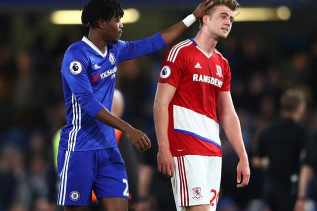 Patrick Bamford is consoled by a former teammate as Middlesborough are relegated from the Premier League.