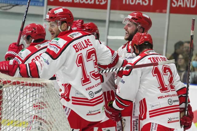 END GAME: Swindon's players celebrate Jack Goodchild's 56th-minute winner. Picture courtesy of Kat Medcroft/SwindonWildcats